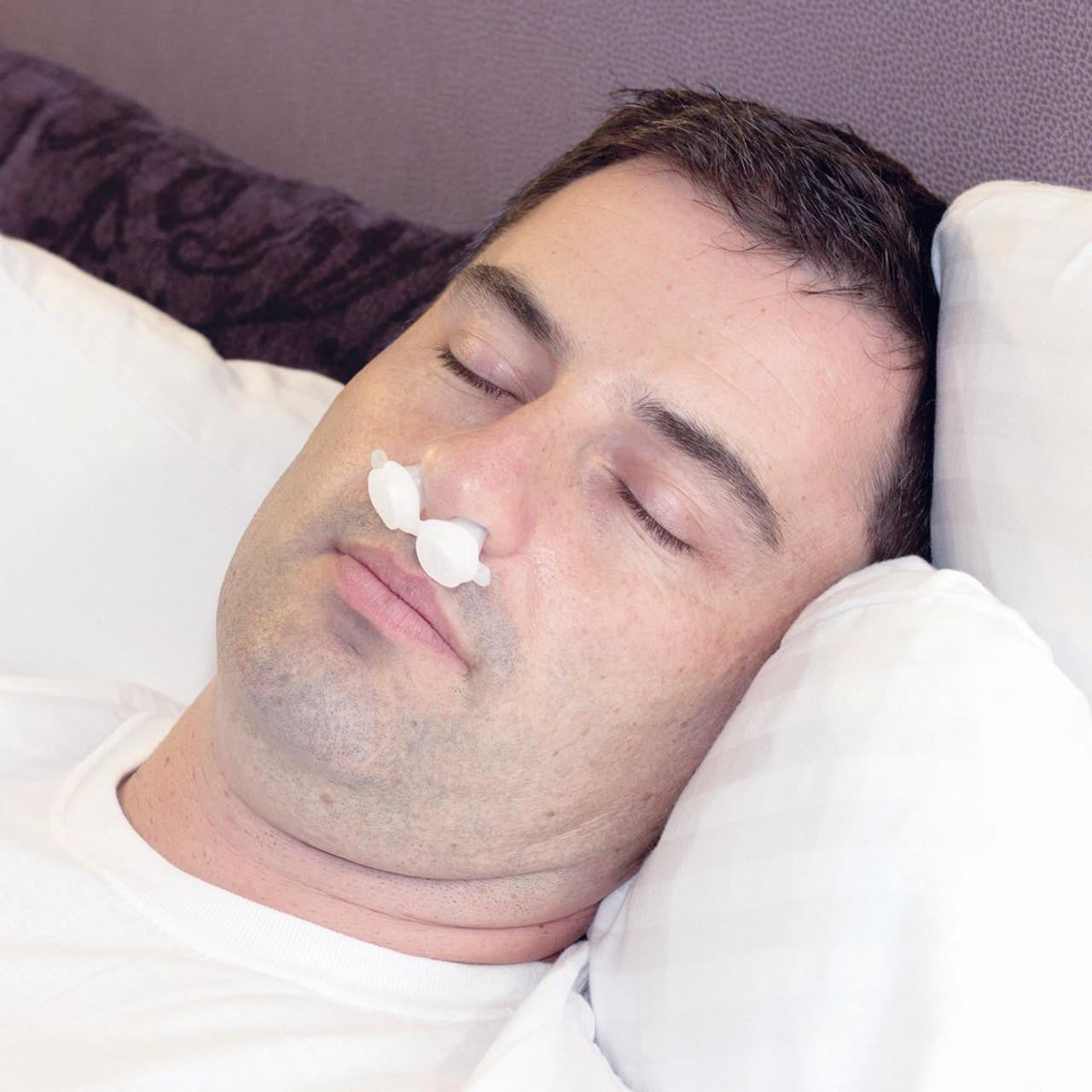 B Medical BongoRx, a portable oxygen therapy device, shown on a sleeping man with nasal prongs in a comfortable setting.