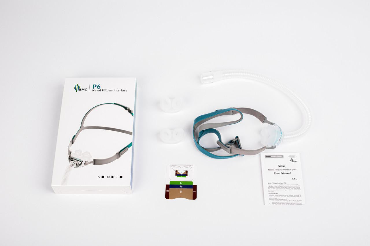 BMC P6 Nasal Pillows CPAP Mask Fitpack, all sizes included, with adjustable headgear, clear nasal pillows, flexible tubing, and user manual on a white background.