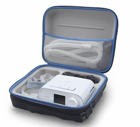 Philips Respironics DreamStation Travel Case, open case showing a portable CPAP machine and accessories inside.