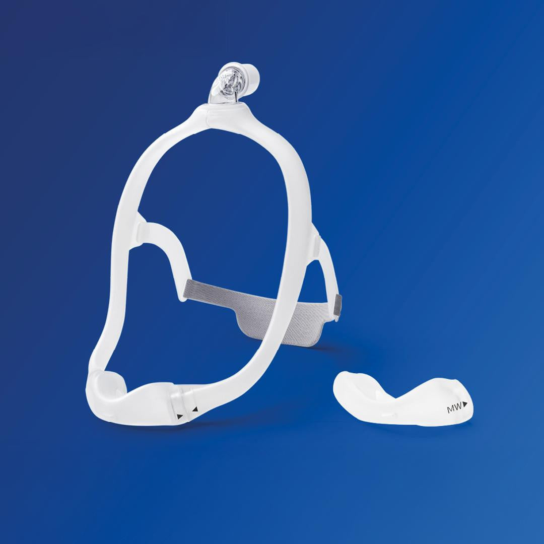 Philips Respironics Philips DreamWear Nasal Cushion Mask FitPack, a medical sleep apnea device with soft nasal cushion and adjustable headgear on a blue background.