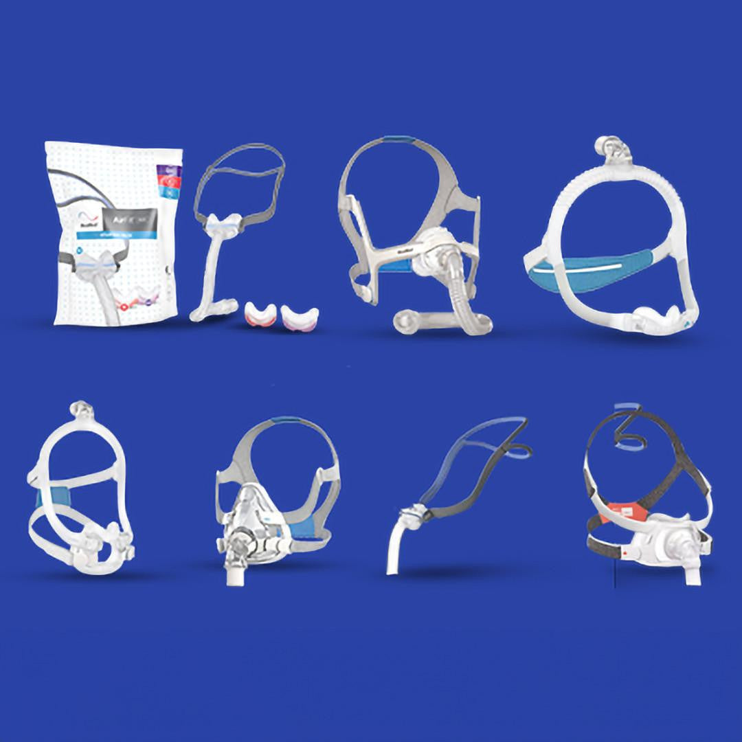 Resmed AirFit Masks, collection of various nasal and full-face CPAP masks and replacement cushions on a blue background.