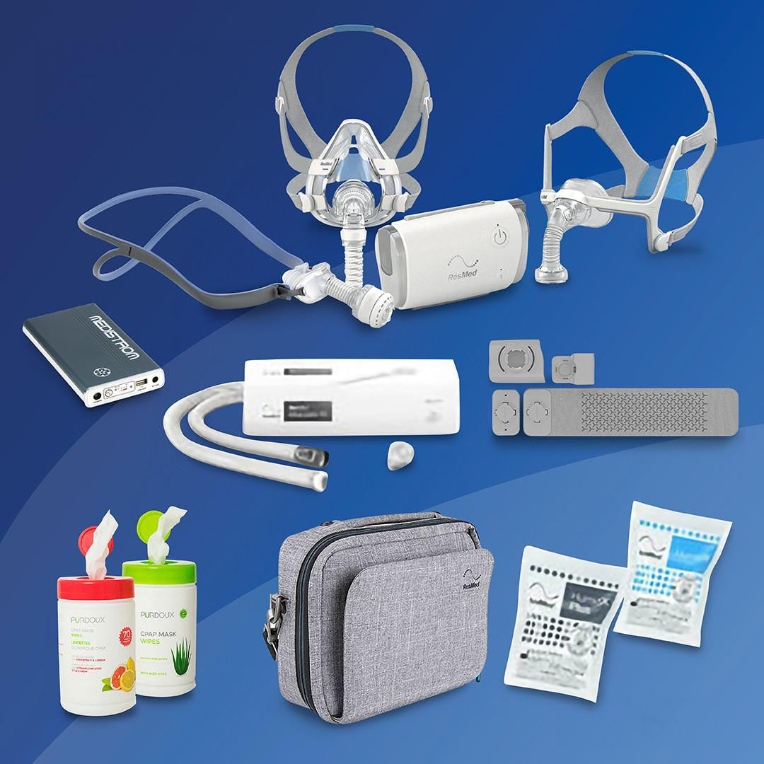 Resmed Airmini Ultimate Travel Pack + Battery, portable CPAP travel device with accessories including masks, tubing, padding, carrying case, and disinfectant wipes.