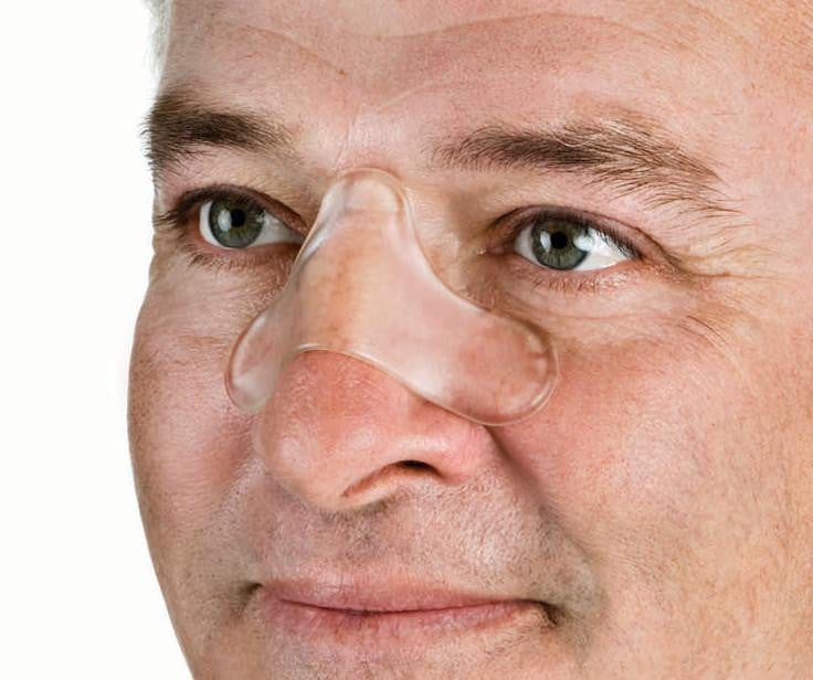 Resmed Gecko Nasal Pads, close-up of a man wearing nasal pads for CPAP therapy.