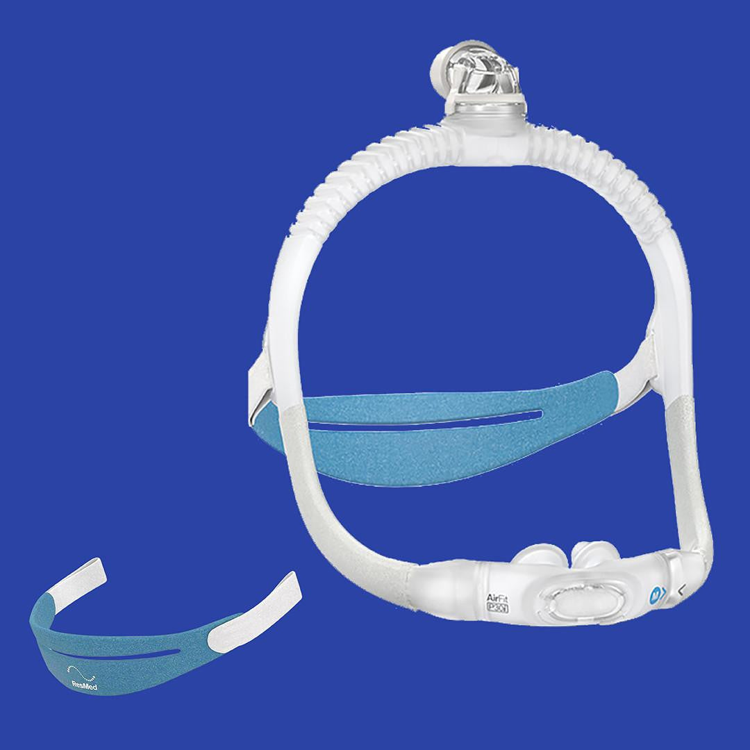 Resmed AirFit P30i Pillows mask, clear mask with blue and white components and a bonus strap in front of a blue background.
