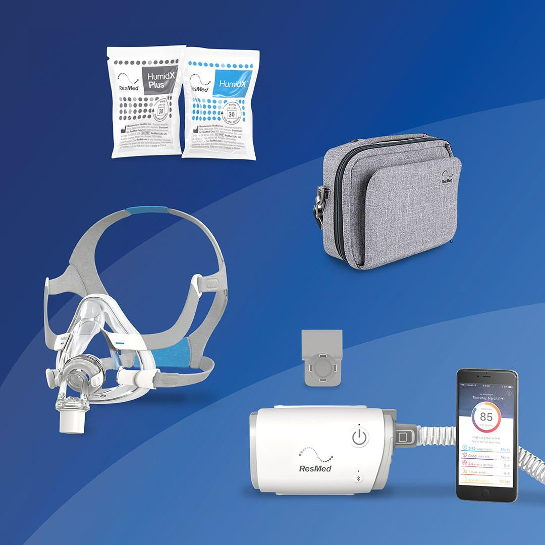 ResMed AirMini - F20 Starter kit + Deluxe Bag, containing a portable CPAP device, a gray carrying bag, a mask with headgear, replacement humidifier chambers, and a smartphone displaying sleep data.