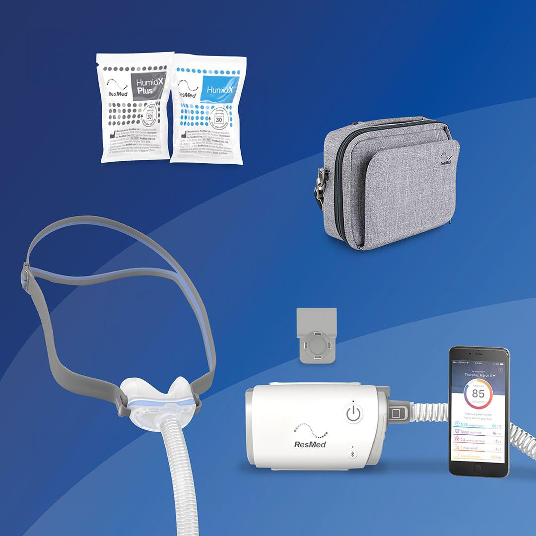 Resmed ResMed AirMini - N30 Starter kit + Deluxe Bag, including a compact portable CPAP machine, a tube with a mask, two humidX Plus moisture cartridges, a grey carrying case, and a smartphone app for monitoring sleep therapy.