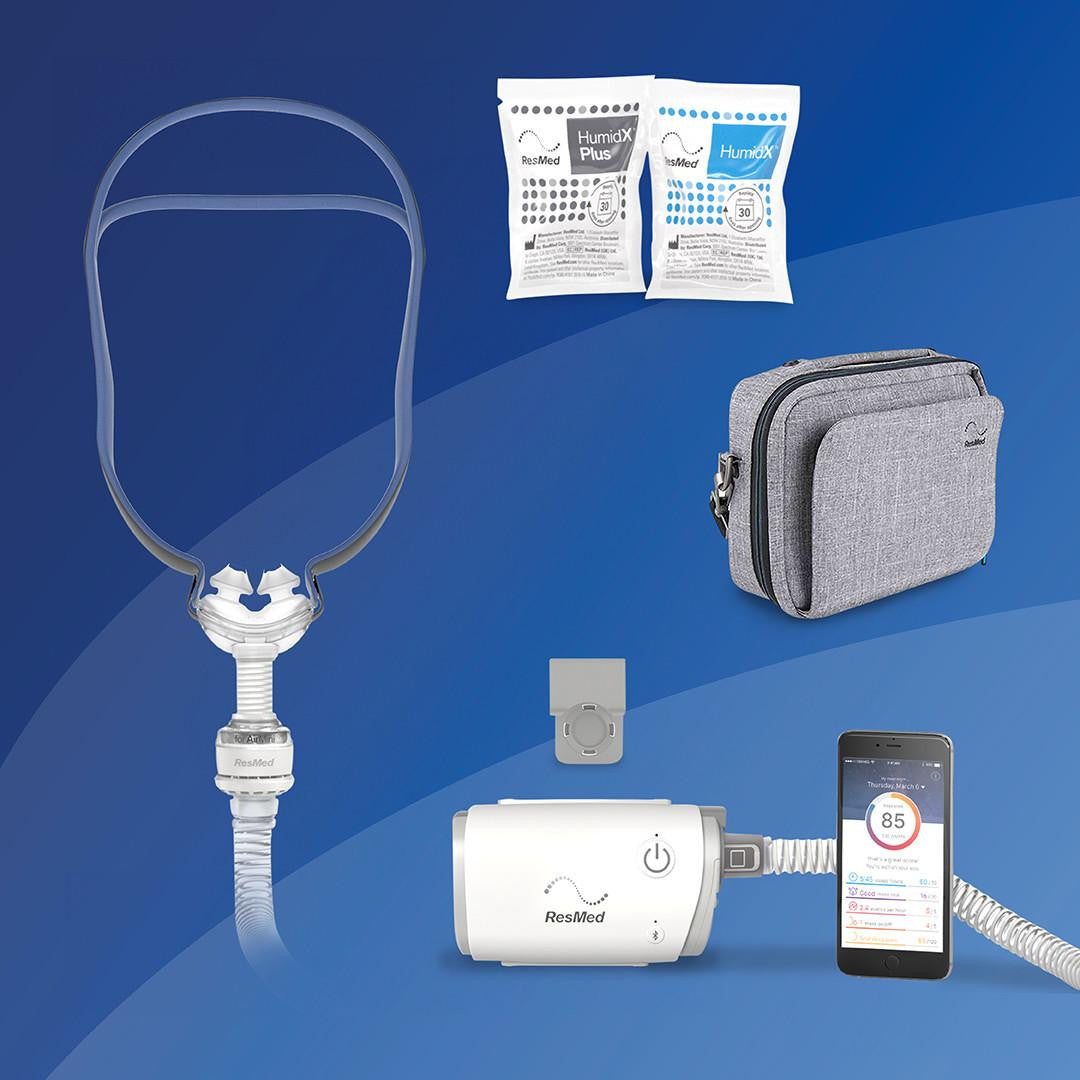 Resmed AirMini - P10 Starter kit+ Deluxe Bag, image of the portable CPAP machine with accessories including humidX filters, a grey carrying bag, and a smartphone displaying sleep data.