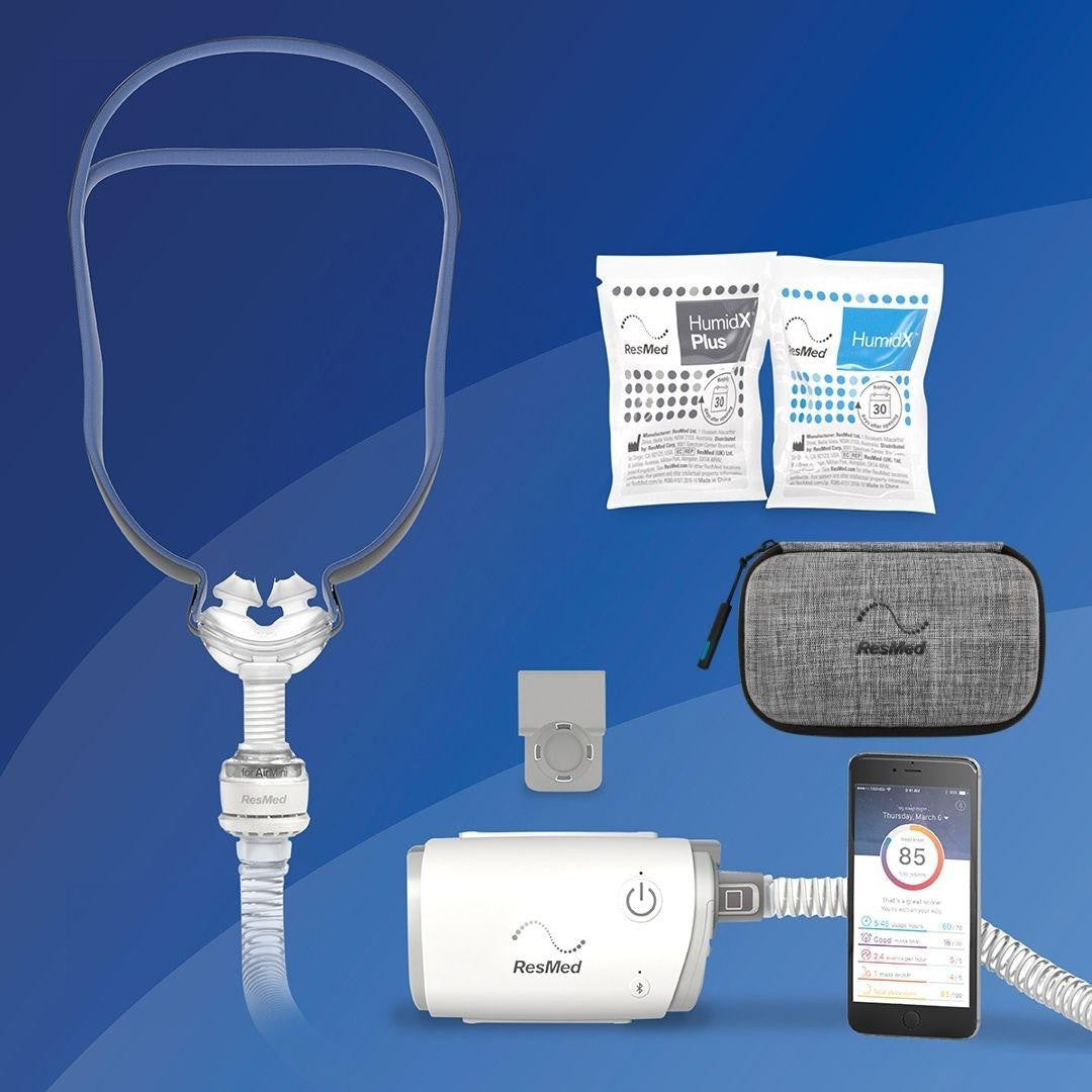 ResMed AirMini - P10 Starter kit+ Deluxe Bag, image shows the portable CPAP device with accessories including nasal pillows, humidifier sachets, a storage case, and a smartphone displaying sleep data.