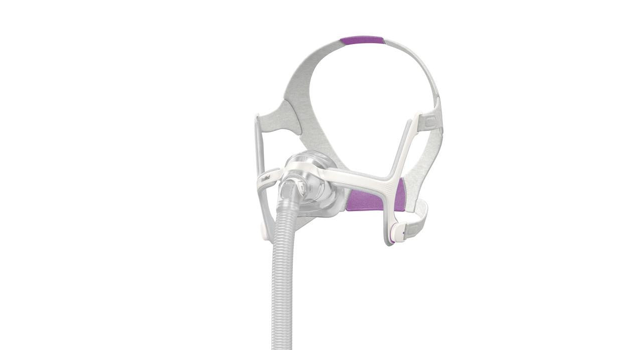 ResMed AirTouch N20 For Her, a wearable CPAP mask with a soft, pink and white design and adjustable headgear for comfortable sleep therapy.